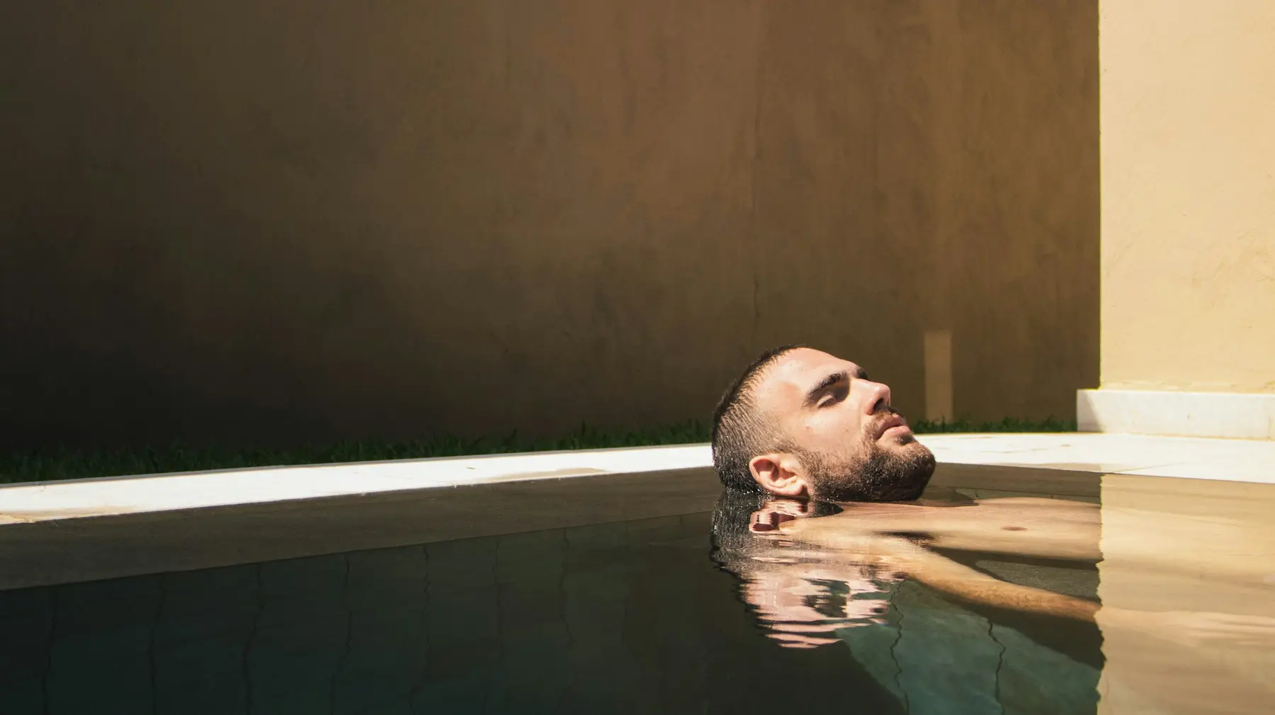 A man floating in warm water