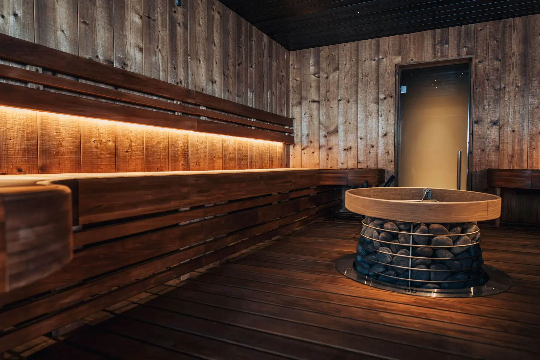 A long wooden sauna lit from below