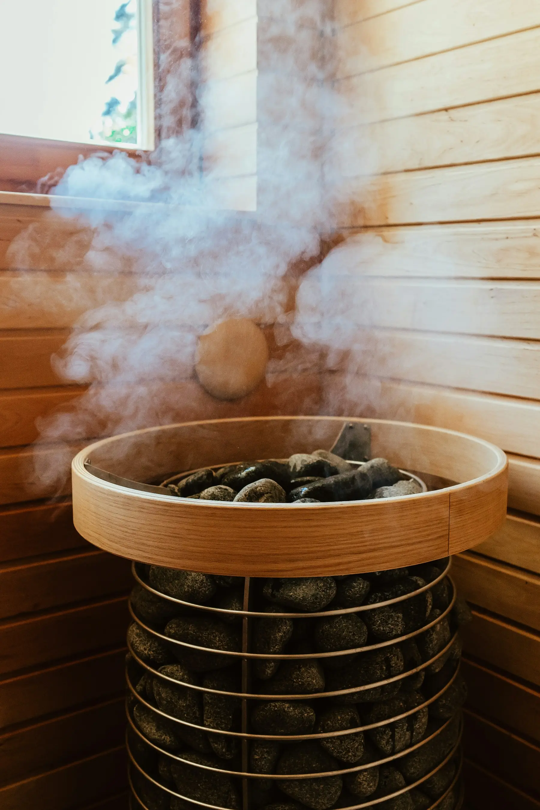 Steam rising off hot stones in a sauna